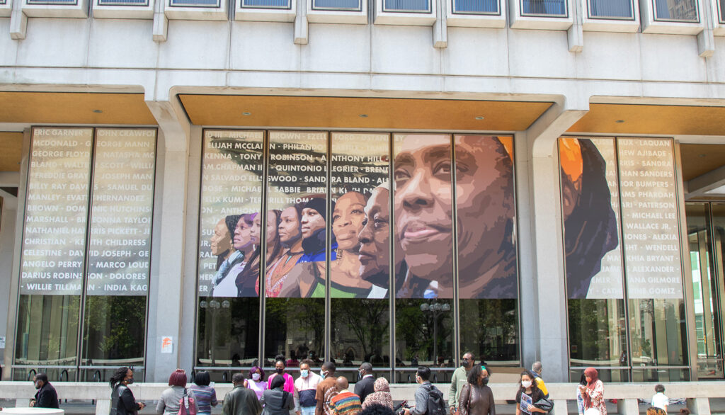 Image of City building with projection of diverse faces